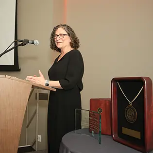 Michelle Perry speaking at a podium