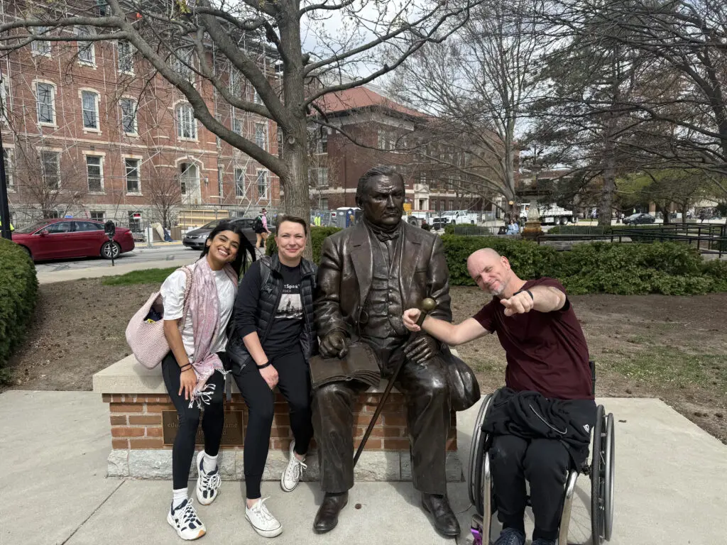Vanessa Hernandez, Silva Laukkanen, and Dwayne Scheuneman pose with a statue of John Purdue on Purdue University’s West Lafayette, IN, campus.